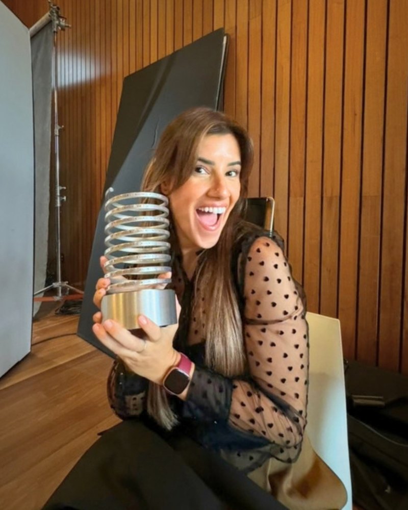 Veronica holding a Webby Award statue