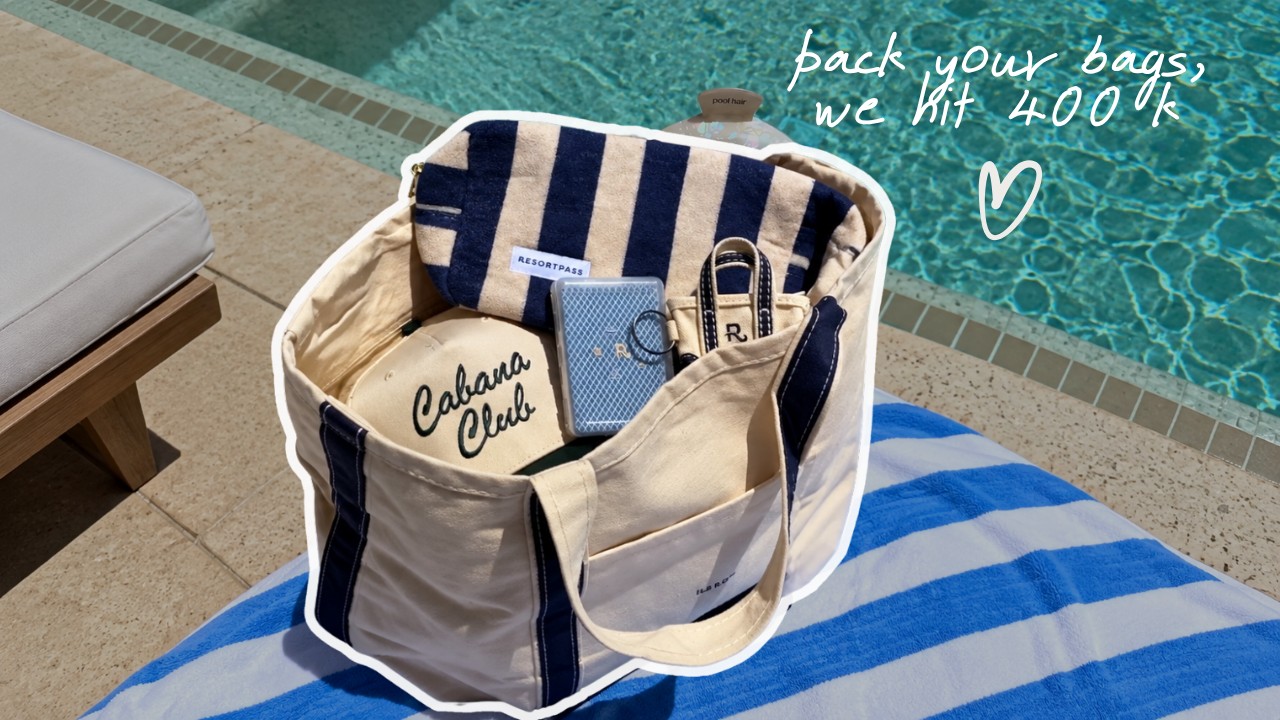 The ResortPass summer kit tote bag by a pool, captioned pack your bags, we hit 400k