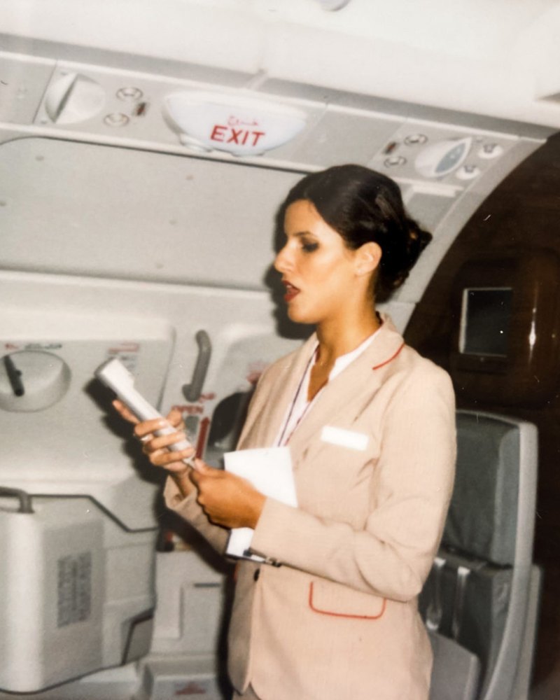Veronica in her Emirates uniform giving an announcement on board